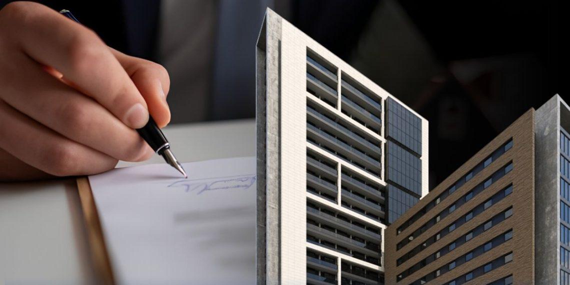 Close-up of a hand signing a document with a miniature modern skyscraper model in the foreground, implying real estate or architecture contracts.