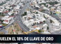 Aerial view of a circular city road with a bold news banner at the bottom reading 'DEMULEN EL 18% DE LLAVE DE ORO'.